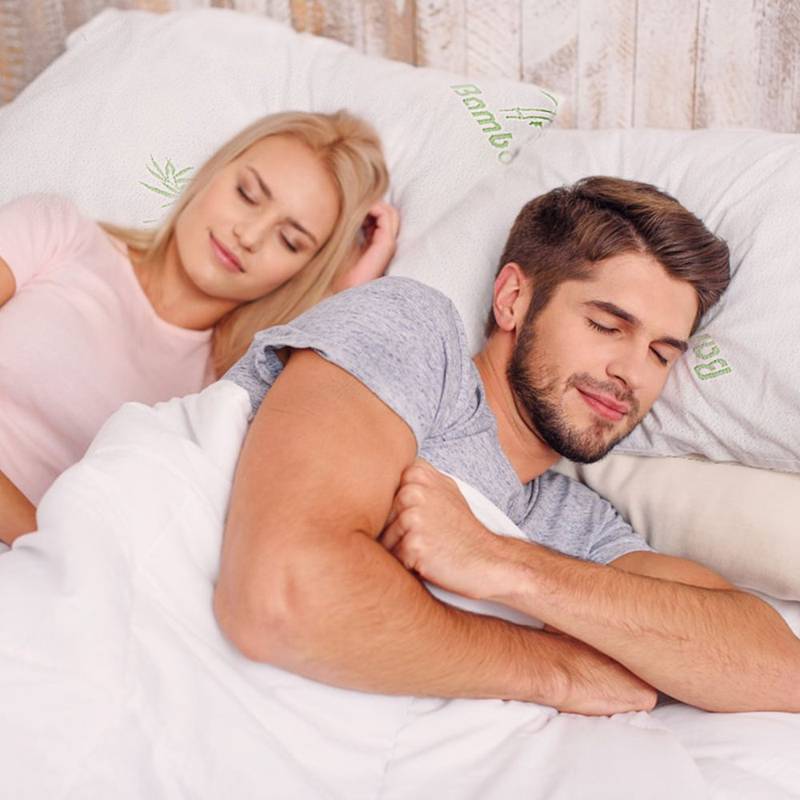 A couple sleeping on two pillows